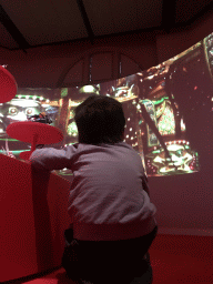 Max with statuettes and movie at the Cool Japan exhibition at the Second Floor of the Tropenmuseum