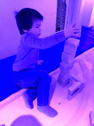 Max playing with blocks at the scale model of a Kasba at the ZieZo Marokko exhibition at the First Floor of the Tropenmuseum