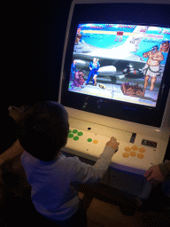 Max with an arcade game at the Cool Japan exhibition at the Second Floor of the Tropenmuseum