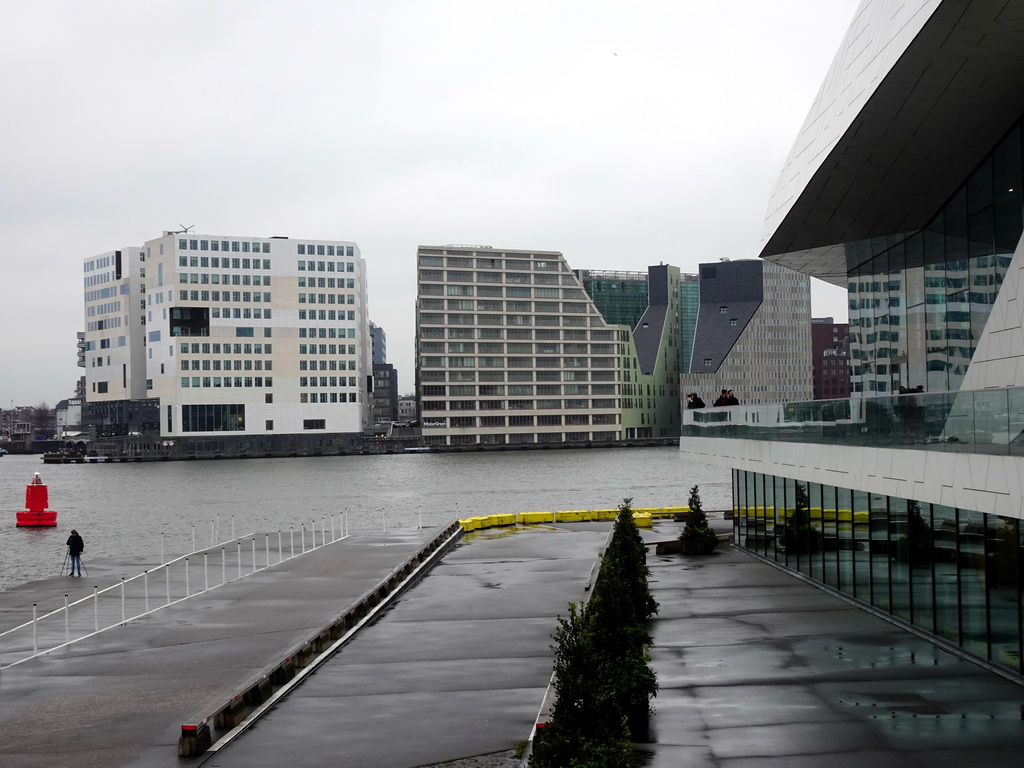 The IJpromenade, the side of the EYE Film Institute Netherlands, the IJ river and buildings at the IJdock area