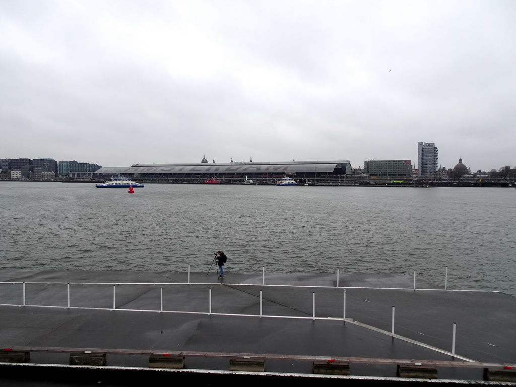 Boats in the IJ river, the Amsterdam Central Railway Station, the Hotel Ibis Amsterdam Centre, the Silver Tower and the Renaissance Koepelkerk conference center, viewed from the IJpromenade