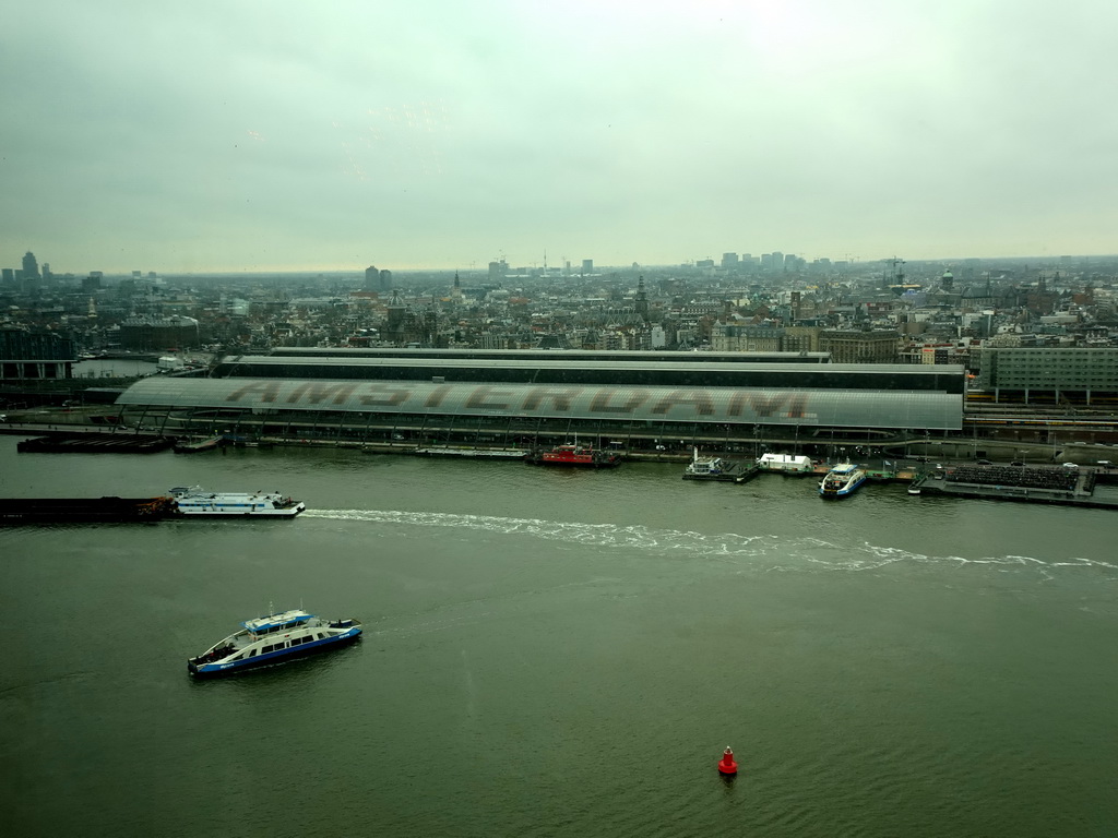 Boats in the IJ river and the city center with the Amsterdam Central Railway Station, viewed from the A`DAM Lookout Indoor observation deck at the A`DAM Tower