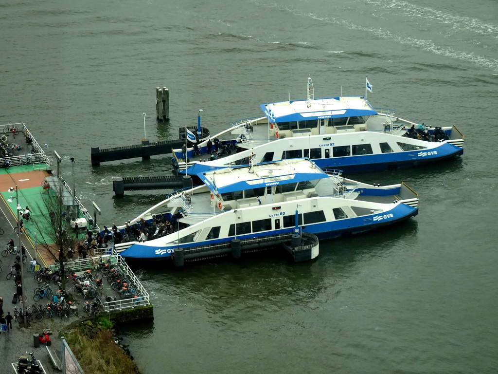Two ferries at the Buiksloterweg terminal at the IJ river, viewed from the A`DAM Lookout Indoor observation deck at the A`DAM Tower