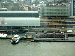 Ferry at the Central Station terminal at the IJ river and the Amsterdam Central Railway Station, viewed from the A`DAM Lookout Indoor observation deck at the A`DAM Tower