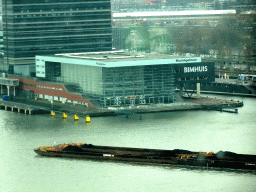Boat in the IJ river and the Muziekgebouw aan `t IJ concert hall, viewed from the A`DAM Lookout Indoor observation deck at the A`DAM Tower