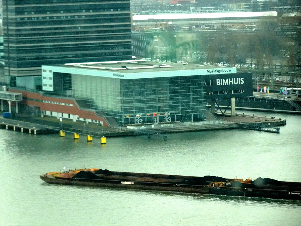 Boat in the IJ river and the Muziekgebouw aan `t IJ concert hall, viewed from the A`DAM Lookout Indoor observation deck at the A`DAM Tower