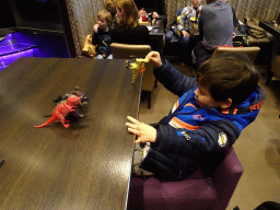 Max playing with dinosaur toys at the FEBO Boulevard restaurant at the Johan Cruijff Arena