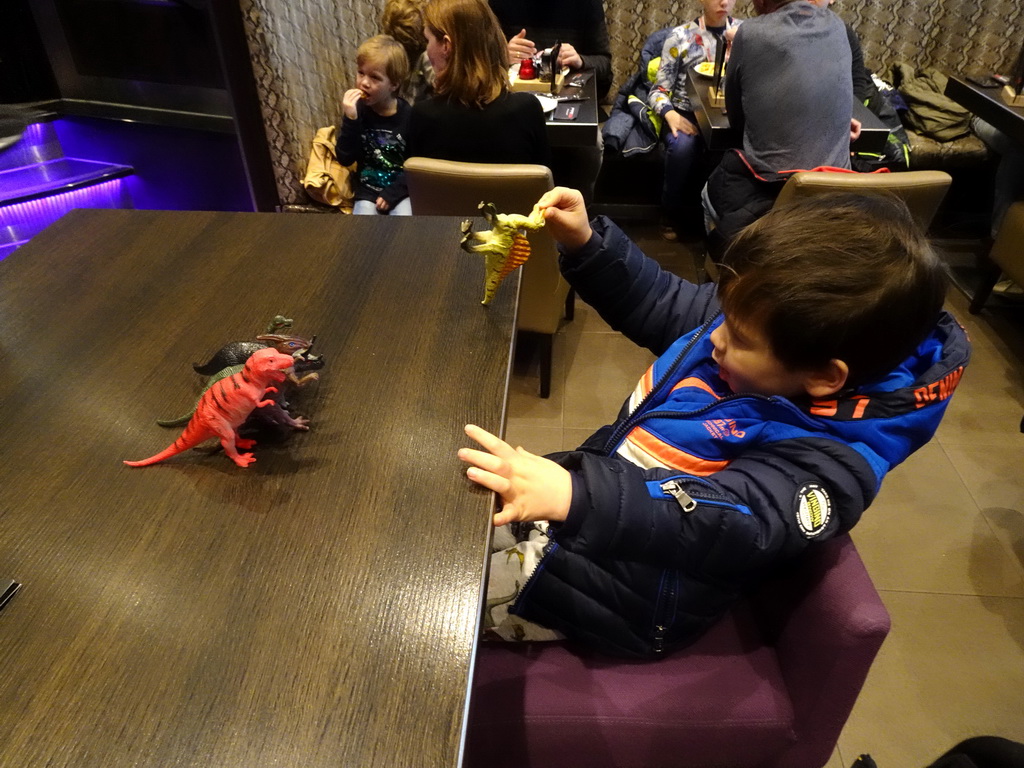 Max playing with dinosaur toys at the FEBO Boulevard restaurant at the Johan Cruijff Arena