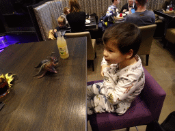 Max playing with dinosaur toys at the FEBO Boulevard restaurant at the Johan Cruijff Arena