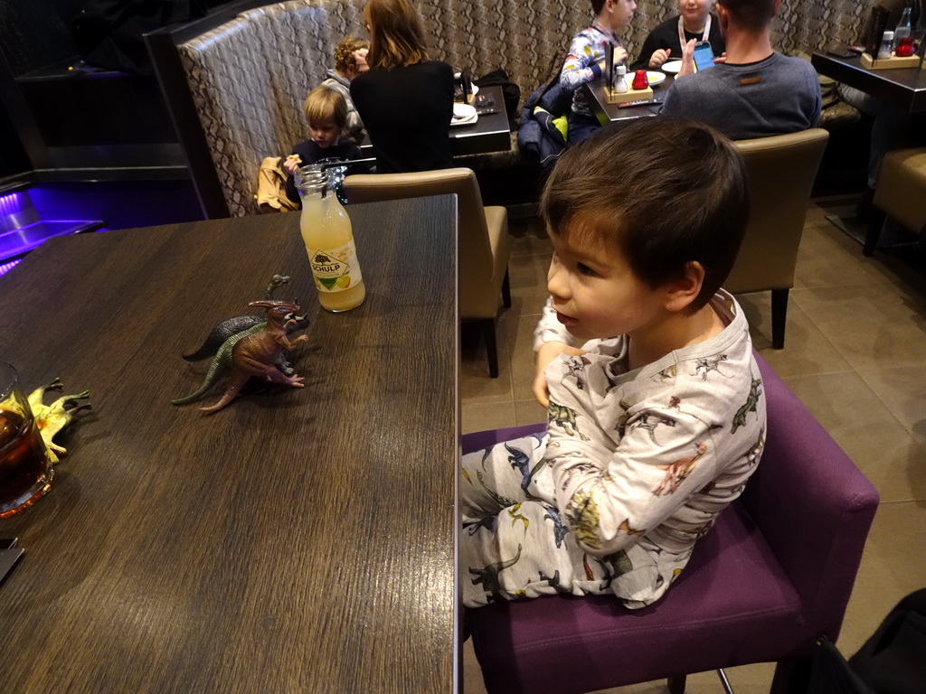 Max playing with dinosaur toys at the FEBO Boulevard restaurant at the Johan Cruijff Arena