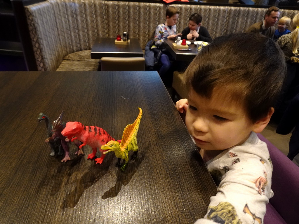 Max playing with dinosaur toys at the FEBO Boulevard restaurant at the Johan Cruijff Arena