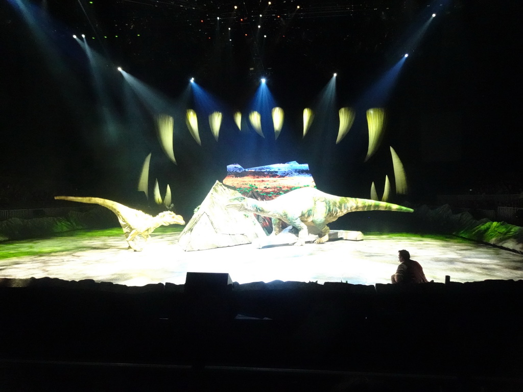 Allosaurus statue, Plateosaurus statue and actor at the stage of the Ziggo Dome, during the `Walking With Dinosaurs - The Arena Spectacular` show