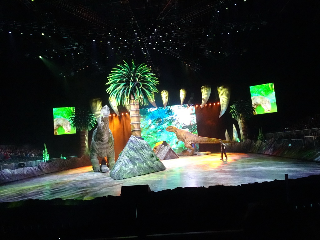 Brachiosaurus statue, Allosaurus statue and actor at the stage of the Ziggo Dome, during the `Walking With Dinosaurs - The Arena Spectacular` show