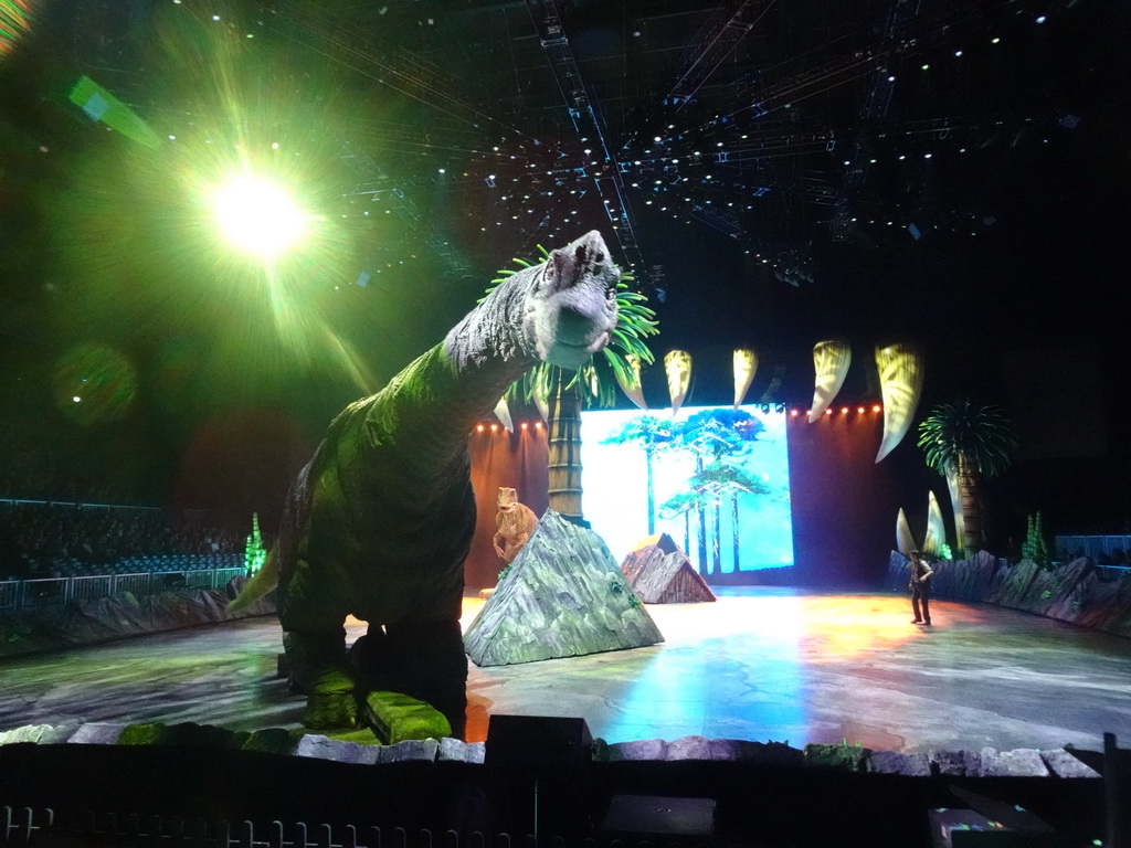 Brachiosaurus statue, Allosaurus statue and actor at the stage of the Ziggo Dome, during the `Walking With Dinosaurs - The Arena Spectacular` show