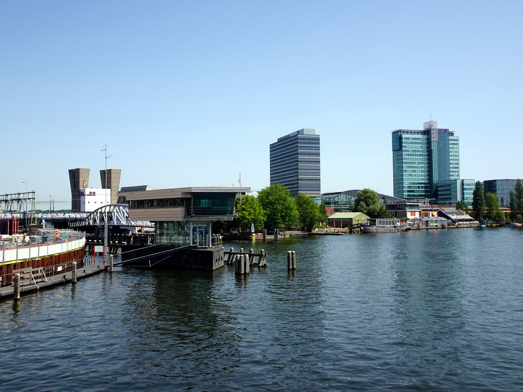 Boat in the Oosterdok canal, the Muziekgebouw aan `t IJ building, the Mövenpick Hotel Amsterdam City Centre and the UP Office Building, viewed from the Mr. J.J. van der Veldebrug bridge