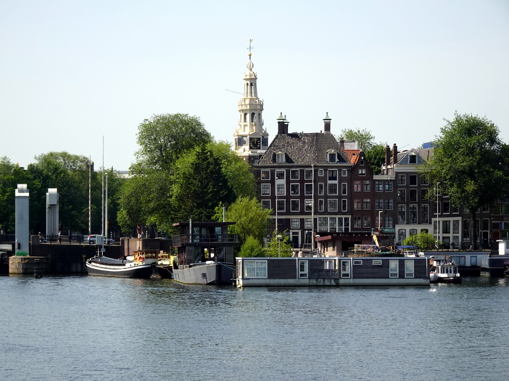 Boats in the Oosterdok canal and the Montelbaanstoren tower, viewed from the Mr. J.J. van der Veldebrug bridge