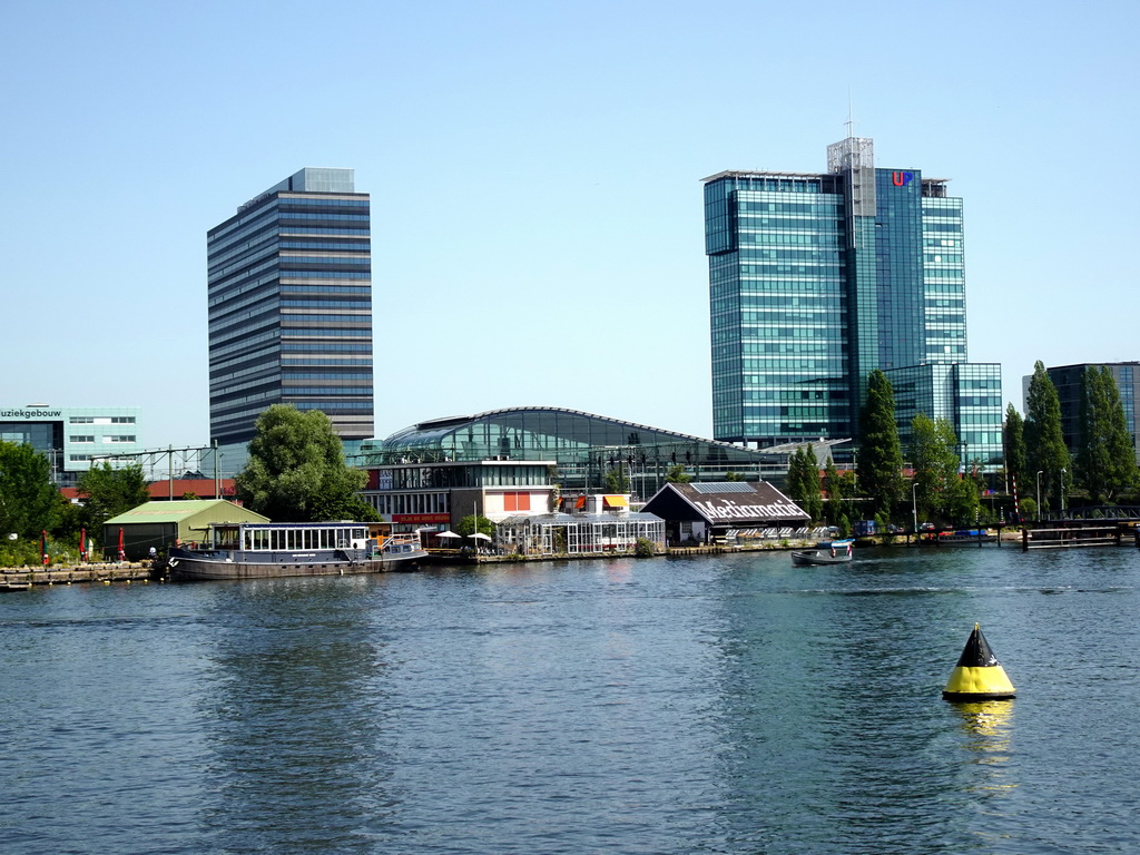 Boat in the Oosterdok canal, the Muziekgebouw aan `t IJ building, the Mövenpick Hotel Amsterdam City Centre and the UP Office Building, viewed from the Mr. J.J. van der Veldebrug bridge