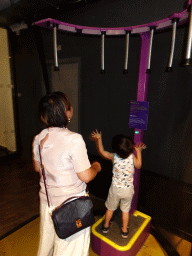 Miaomiao and Max doing a catching game at the Humania exhibition at the Fourth Floor of the NEMO Science Museum
