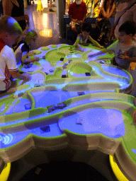 Max playing a flooding game at the Technium exhibition at the Second Floor of the NEMO Science Museum