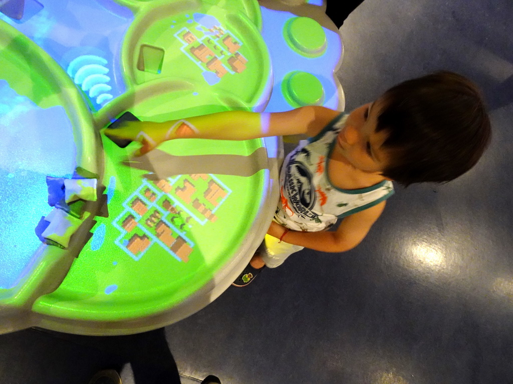 Max playing a flooding game at the Technium exhibition at the Second Floor of the NEMO Science Museum