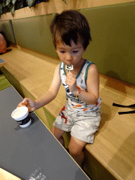 Max licking a lollipop at the Café at the Second Floor of the NEMO Science Museum