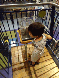 Max turning a wheel at the upper walkway of the Technium exhibition at the Second Floor of the NEMO Science Museum
