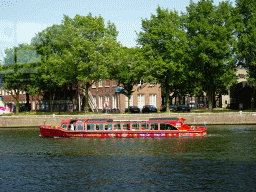 Sightseeing boat on the Oosterdok canal, viewed from the Ground Floor of the NEMO Science Museum