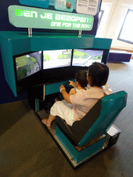 Miaomiao and Max doing a driving game at the Humania exhibition at the Fourth Floor of the NEMO Science Museum