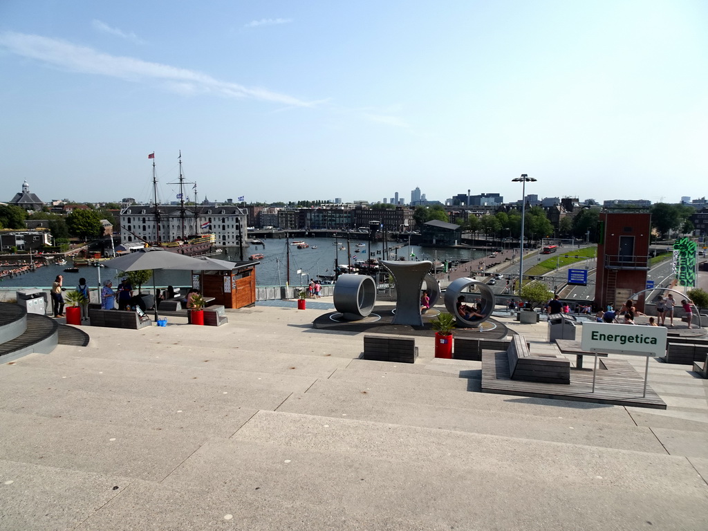 The Energetica exhibition at the roof at the Fifth Floor of the NEMO Science Museum, with a view on the Oosterdok canal and the National Maritime Museum with the replica of the `Amsterdam` ship