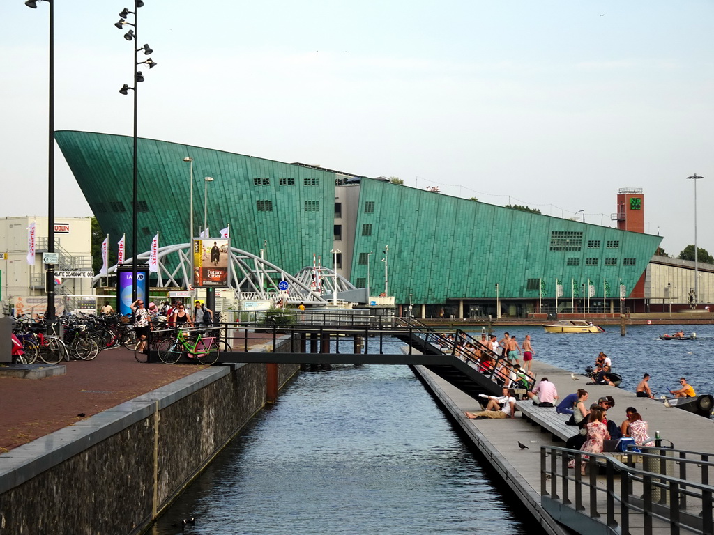 The Oosterdokskade street, the Mr. J.J. van der Veldebrug bridge over the Oosterdok canal and the front of the NEMO Science Museum