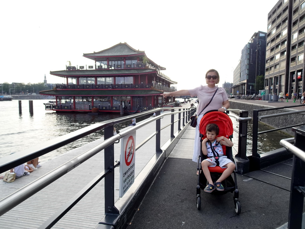 Miaomiao and Max in front of the Sea Palace restaurant at the Oosterdokskade street