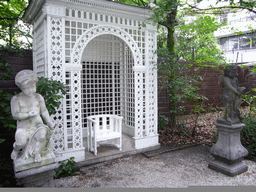 Statues and chair at the garden of the Huis met de Kolommen building