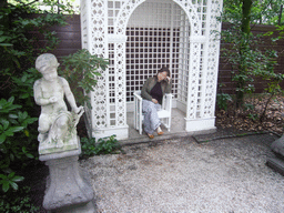 Miaomiao on the chair at the garden of the Huis met de Kolommen building