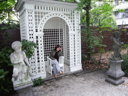 Miaomiao on the chair at the garden of the Huis met de Kolommen building