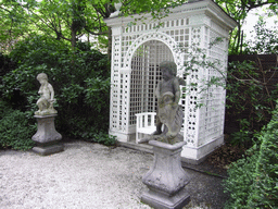 Statues and chair at the garden of the Huis met de Kolommen building