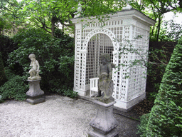 Statues and chair at the garden of the Huis met de Kolommen building