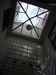 Wall with art and roof window at a building at the Herengracht street