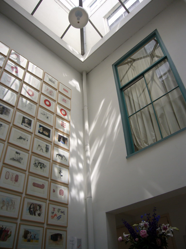 Wall with art and roof window at a building at the Herengracht street