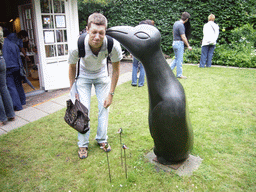 Tim with a penguin statue at the garden of a building at the Herengracht street
