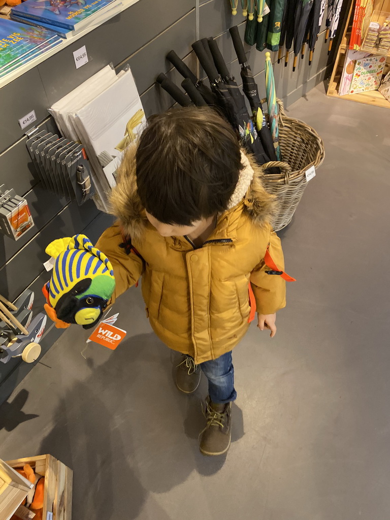 Max with a fish toy at the souvenir shop of the Royal Artis Zoo