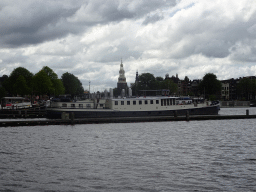 Boats on the Oosterdok canal and the Montelbaanstoren tower, viewed from the Mr. J.J. van der Veldebrug bridge