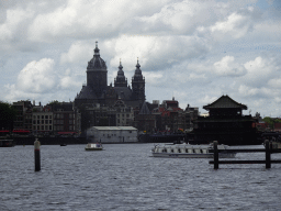 Boats on the Oosterdok canal, the Basilica of Saint Nicholas and the Sea Palace restaurant, viewed from the Mr. J.J. van der Veldebrug bridge