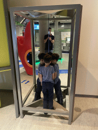 Max with a double mirror at the Fenomena exhibition at the First Floor of the NEMO Science Museum