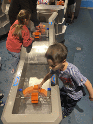 Max building a dam at the Water Power game at the Technium exhibition at the Second Floor of the NEMO Science Museum
