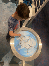 Max with a map at the Energize game at the Technium exhibition at the Second Floor of the NEMO Science Museum