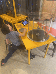 Max with a centrifuge game at the Fenomena exhibition at the First Floor of the NEMO Science Museum