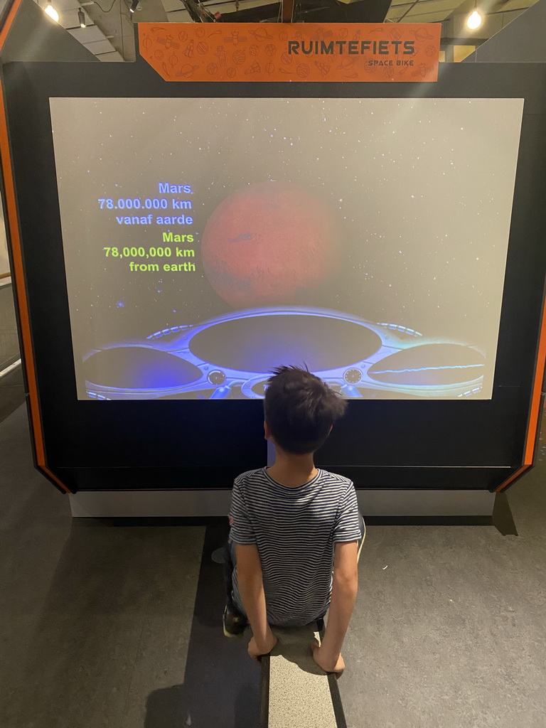 Max at the Space Bike game at the Elementa exhibition at the Third Floor of the NEMO Science Museum