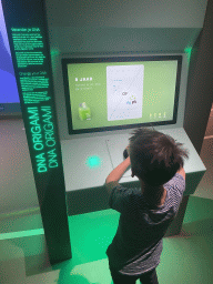 Max with the `DNA Origami` game at the Humania Exhibition at the Fourth Floor of the NEMO Science Museum, with explanation