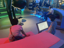Miaomiao and Max playing a sound game and the statue `A Handstand` by Florentijn Hofman at the Humania Exhibition at the Fourth Floor of the NEMO Science Museum