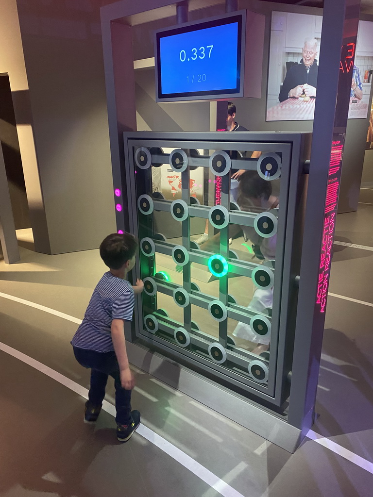 Miaomiao and Max with the Action Reaction game at the Humania Exhibition at the Fourth Floor of the NEMO Science Museum, with explanation